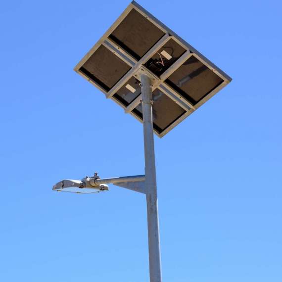 Street light with solar panel on blue sky background. Green energy.